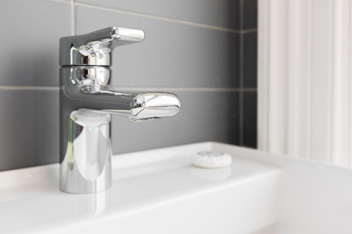 Modern chrome faucet delivering hot water - the daily performance benchmark for any tankless water heater
