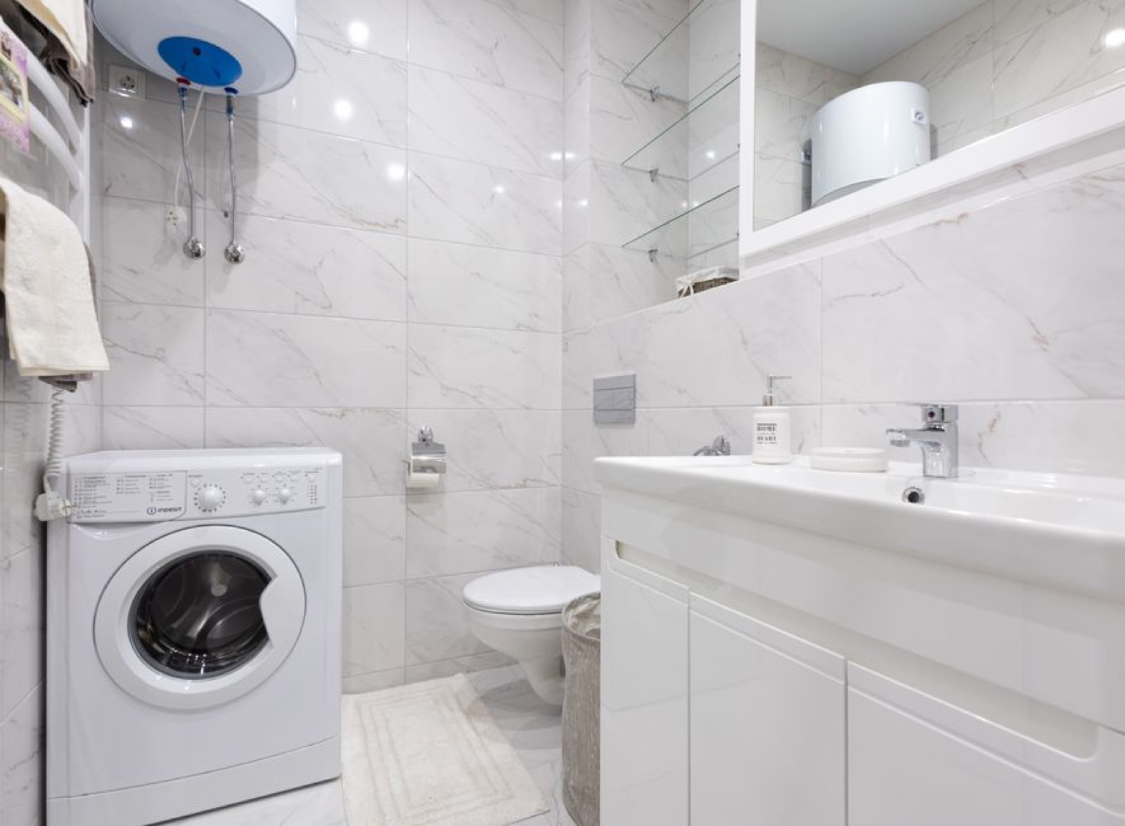 Wall-mounted water heater with connected plumbing in modern bathroom utility area